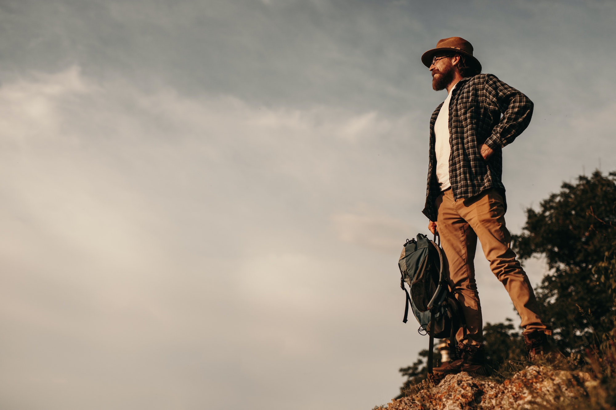 Male traveler standing on top of mountain