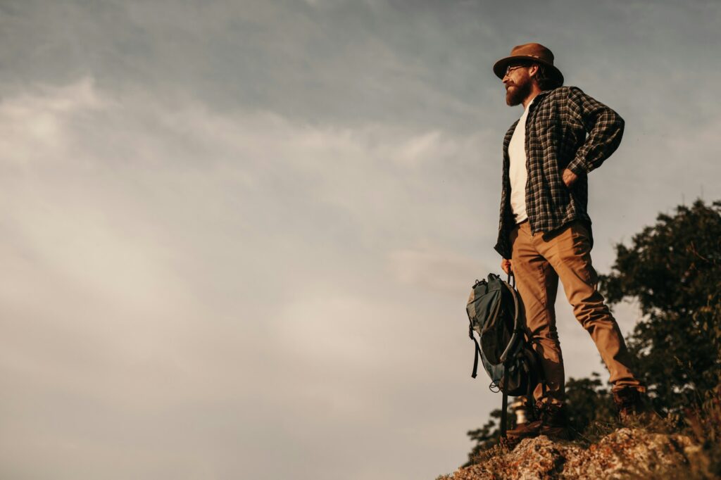 Male traveler standing on top of mountain